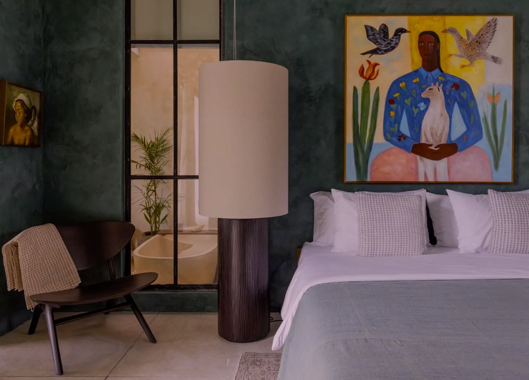 A luxury villa bedroom with art and soft lighting