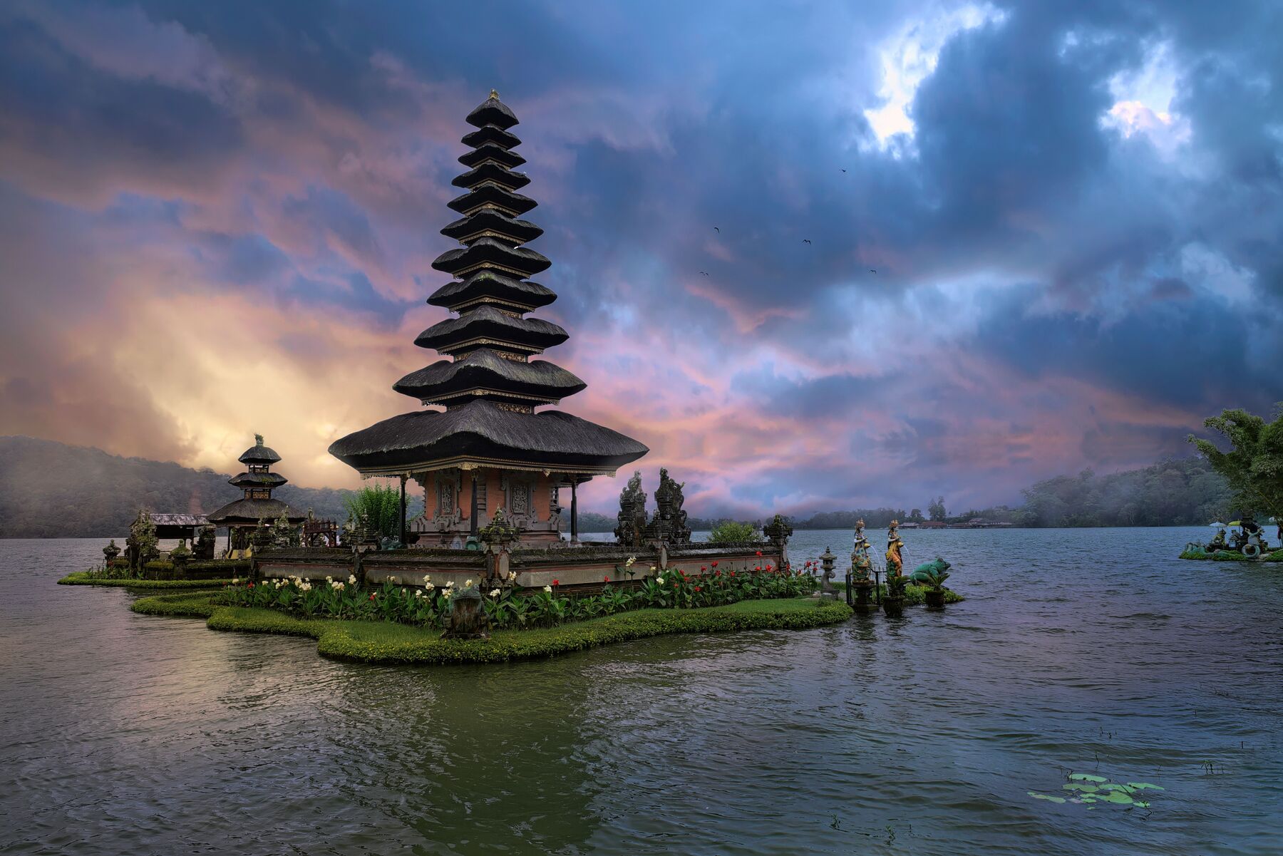 A Balinese temple reflected in still water at dusk