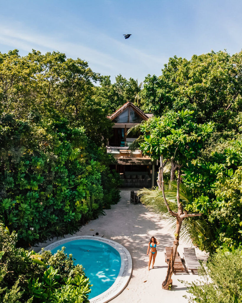 Isabella standing by pool at Soneva Fushi