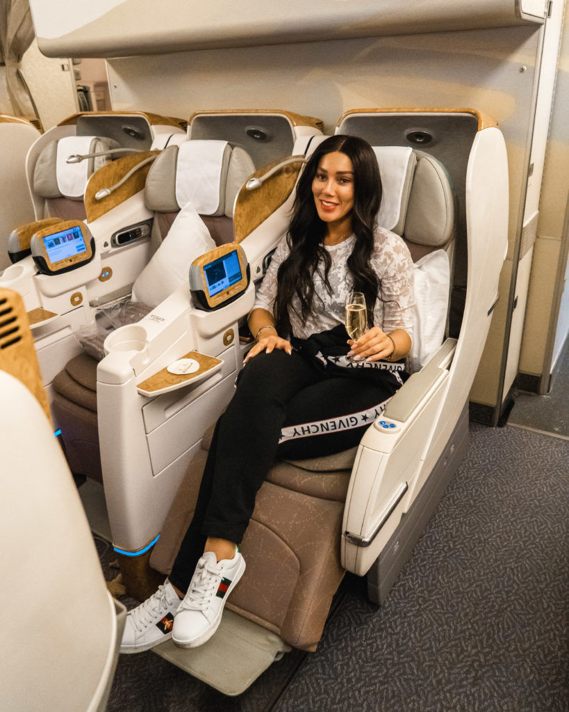 Isabella Garofanelli having a glass of champagne in Emirates Business Class