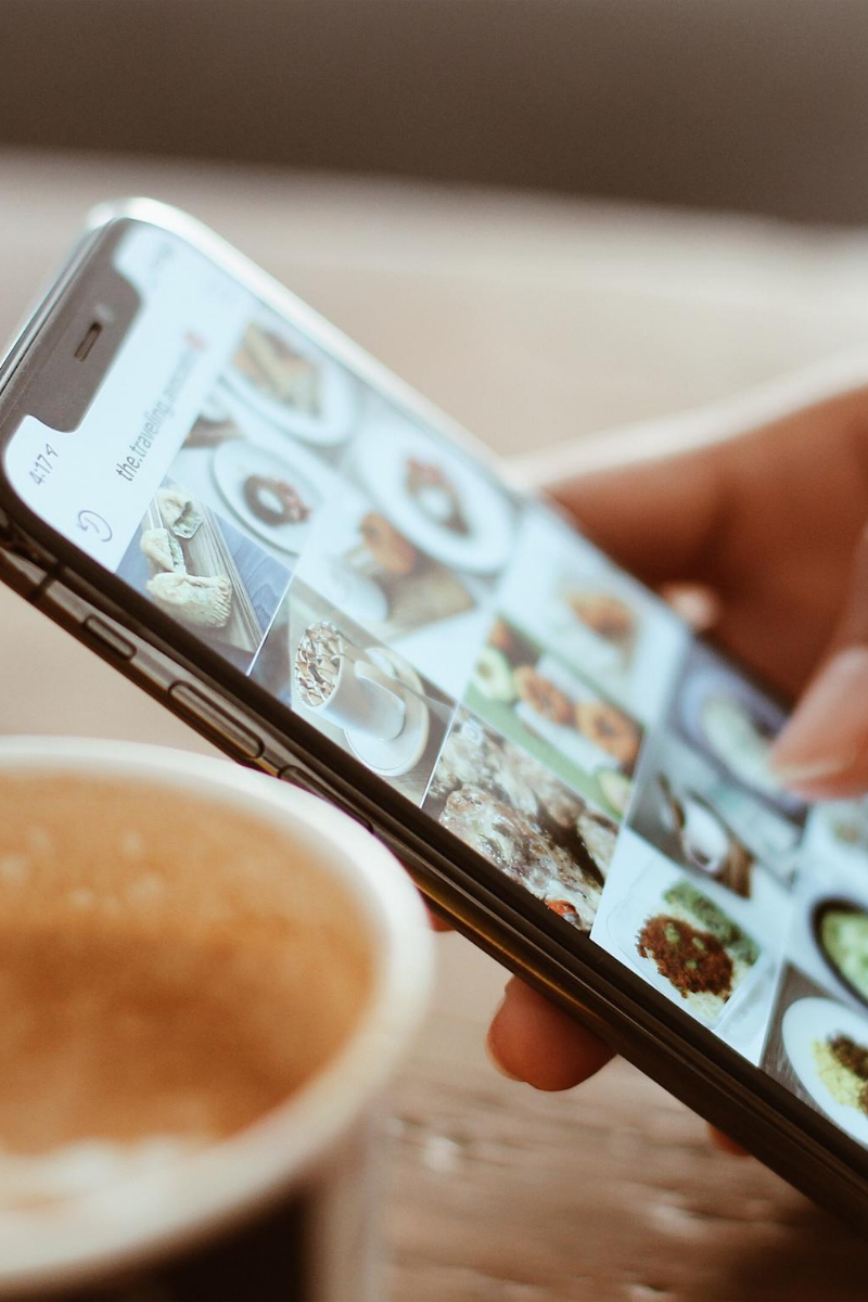 Smartphone showing Instagram and cup of coffee