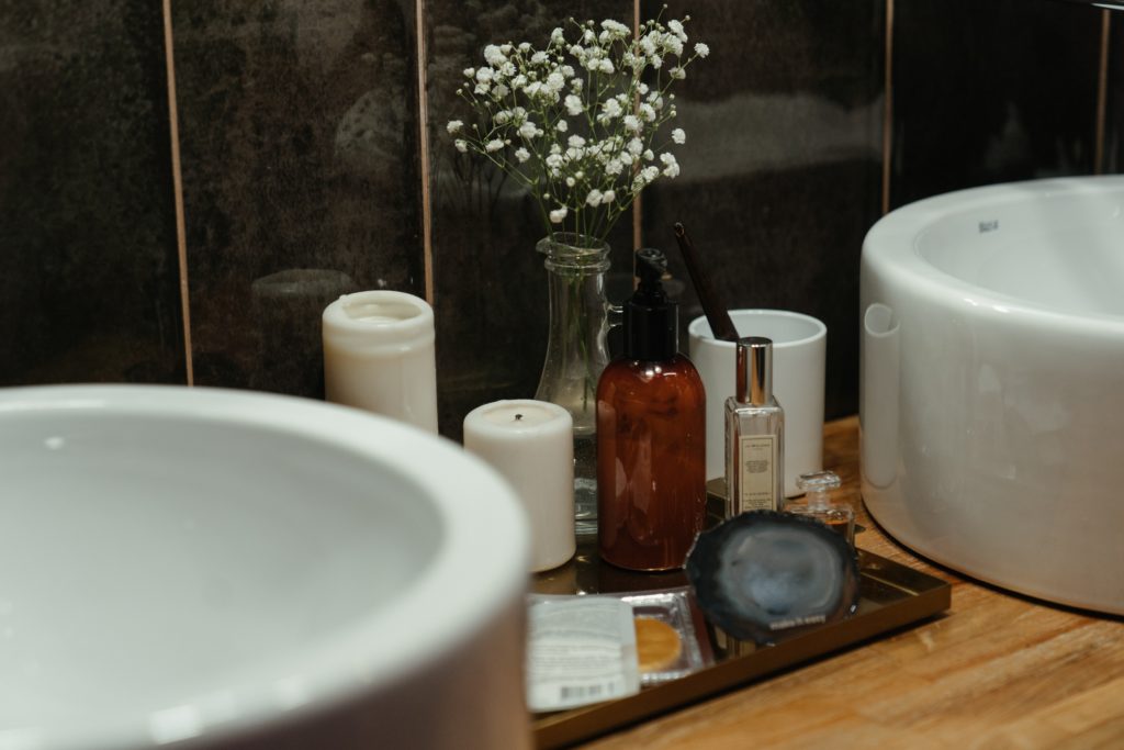 A bathroom sink and candles 