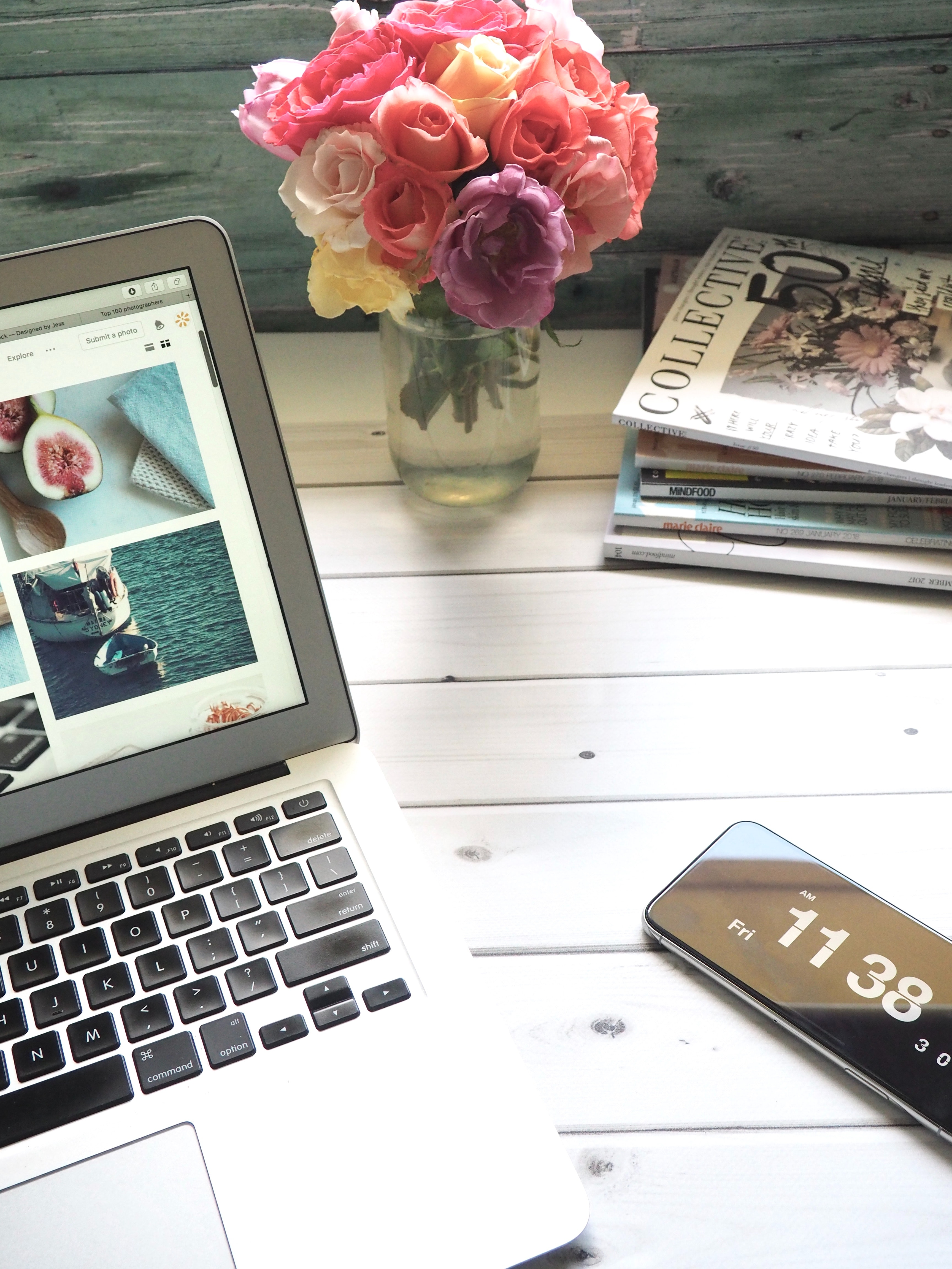 laptop, flowers, phone and magazines