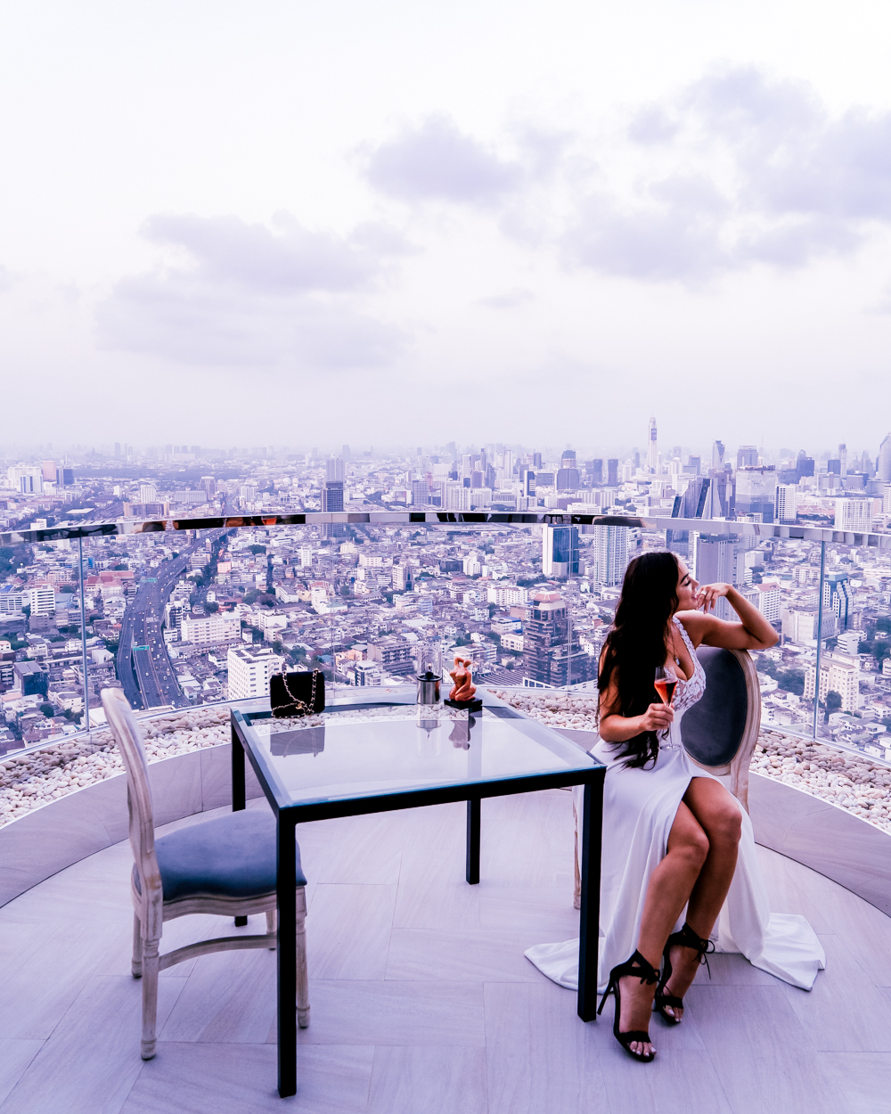 Isabella sitting on the balcony at Lebua Sky Bar, Bangkok, Thailand