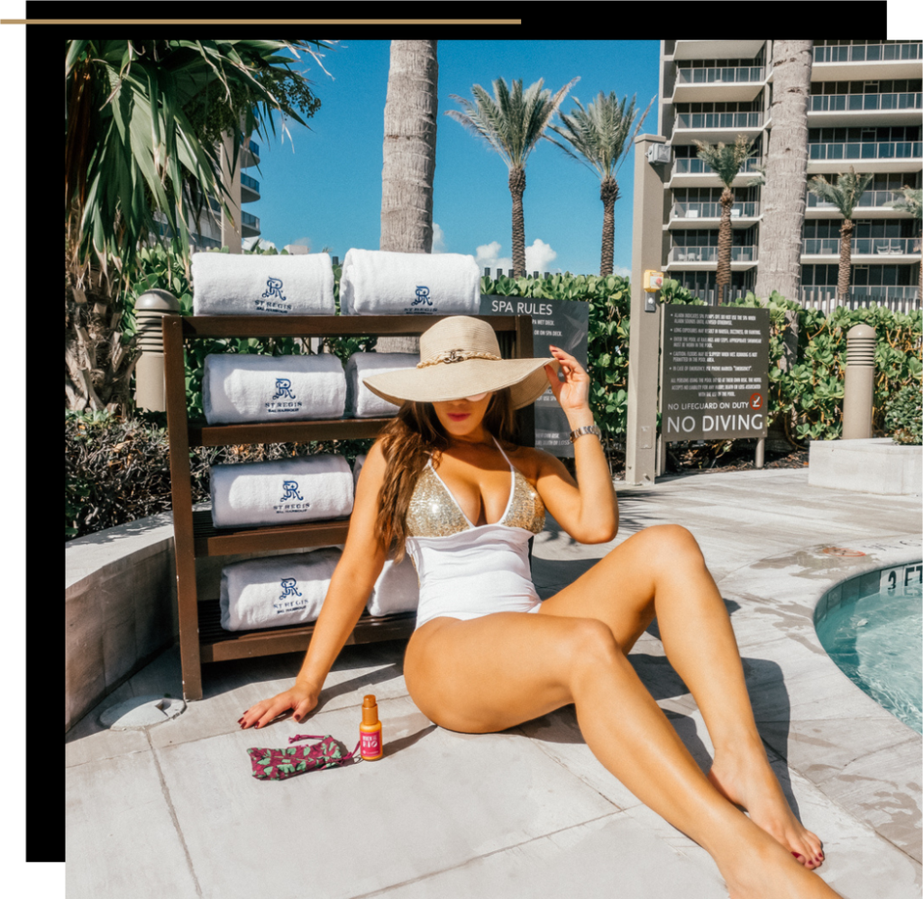 Isabella by the pool in a white swimsuit at the St. Regis Bal Harbour 