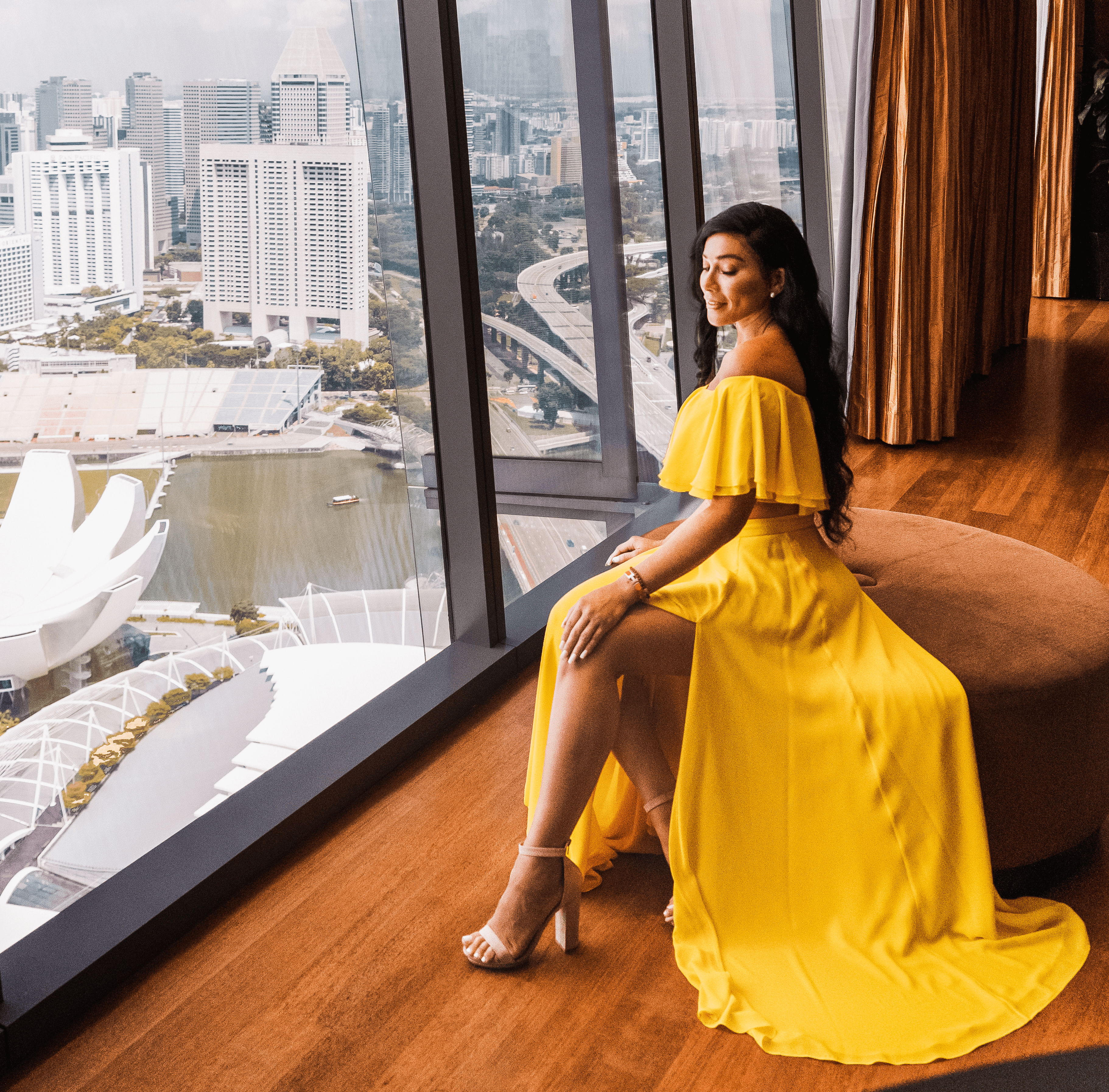 Isabella in the Marina Bay Sands hotel wearing a long yellow dress