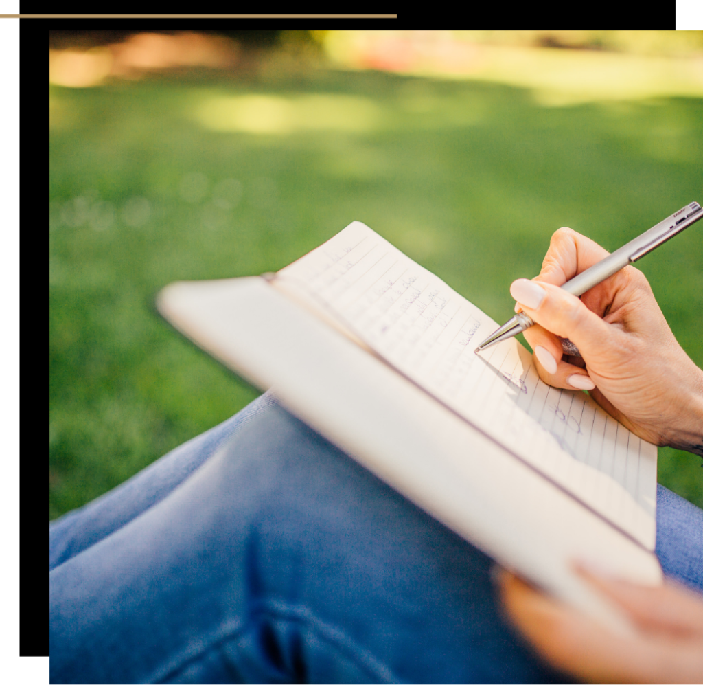 A woman writing in a journal for mental wellbeing