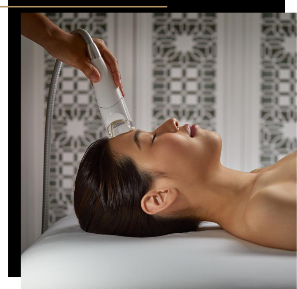 A woman getting an infrared facial treatment at a medical spa