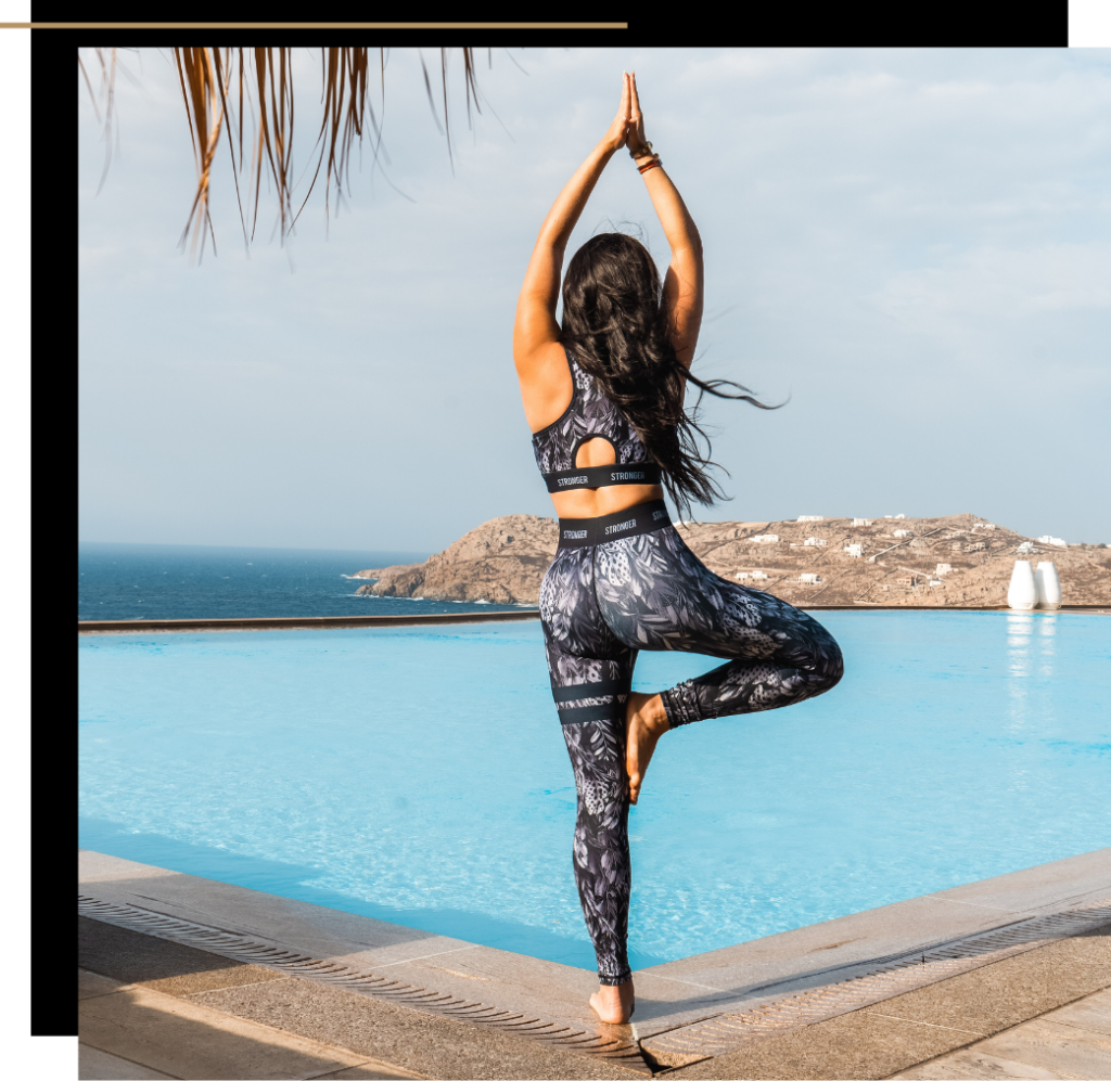 Isabella doing yoga by the pool in activewear for mental wellbeing