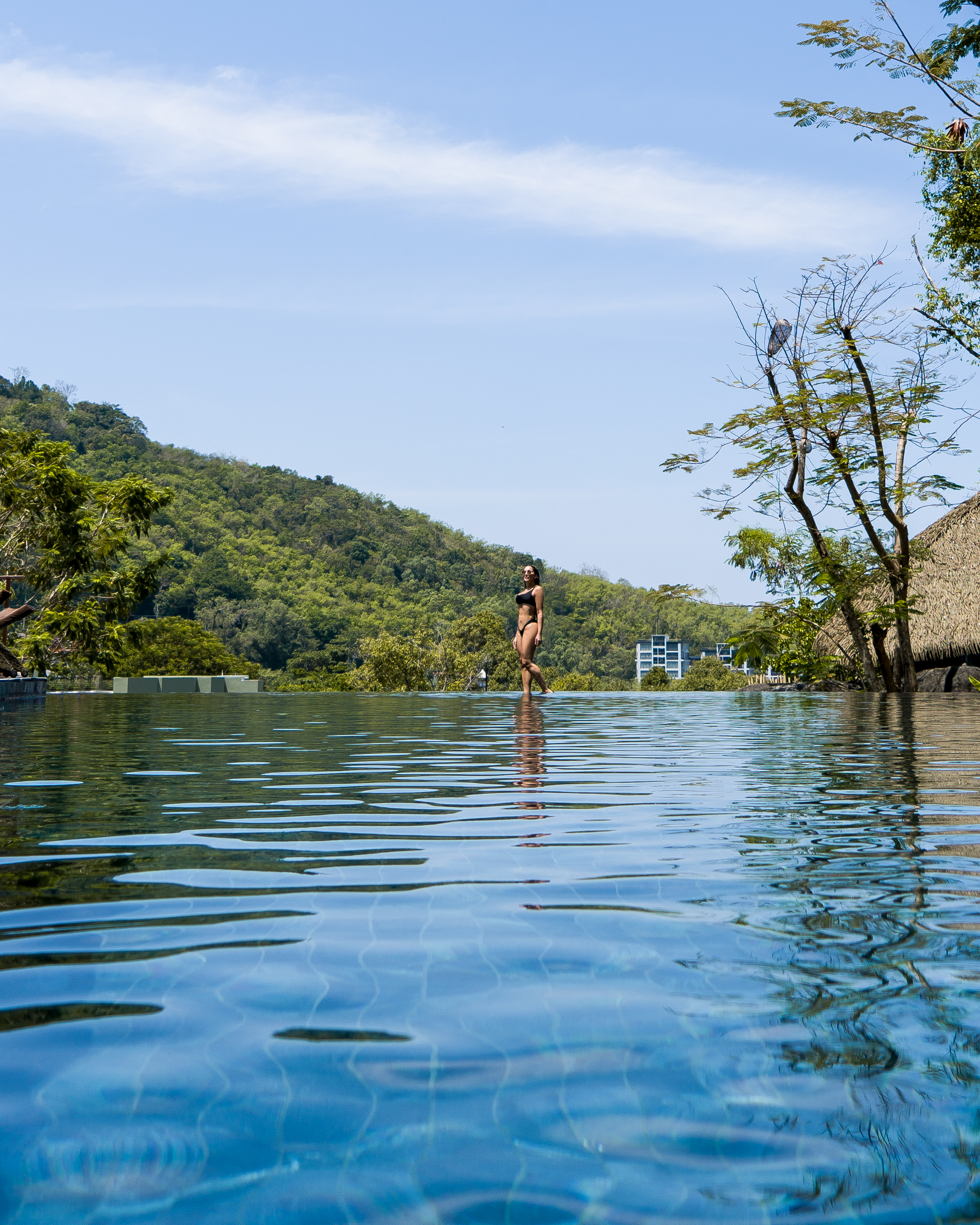 Isabella walking on the edge of the pool in Thailand