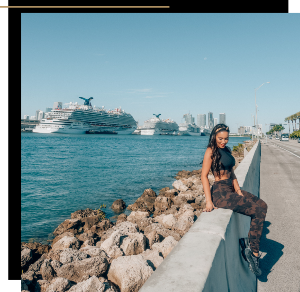 Isabella sitting on a wall watching the cruise ships in Miami