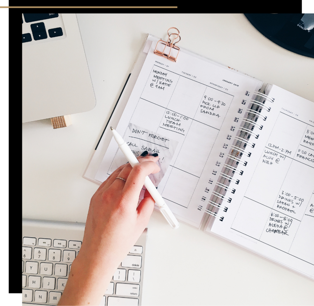 A laptop, keyboard and diary for working from home