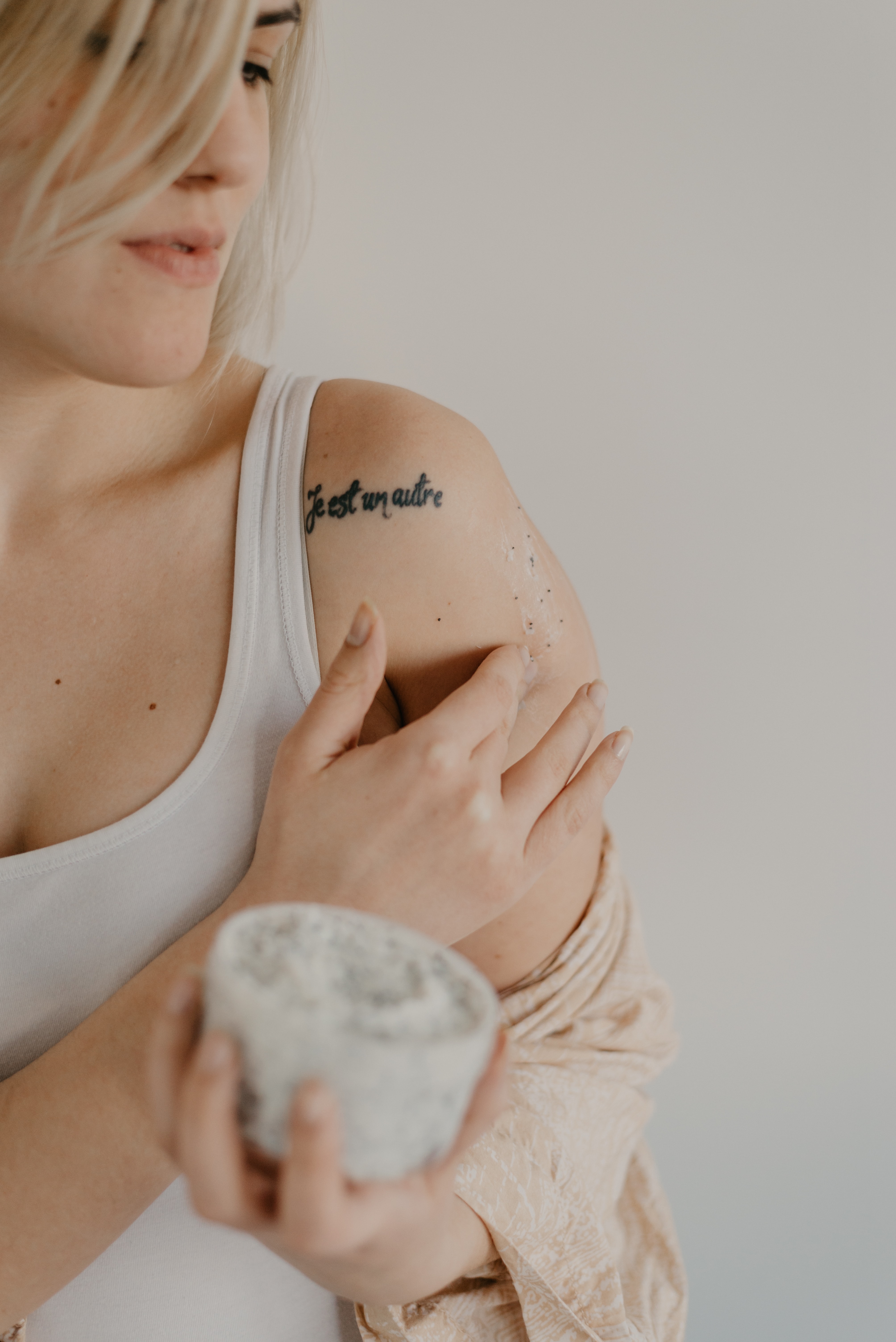 A woman applying a body cream