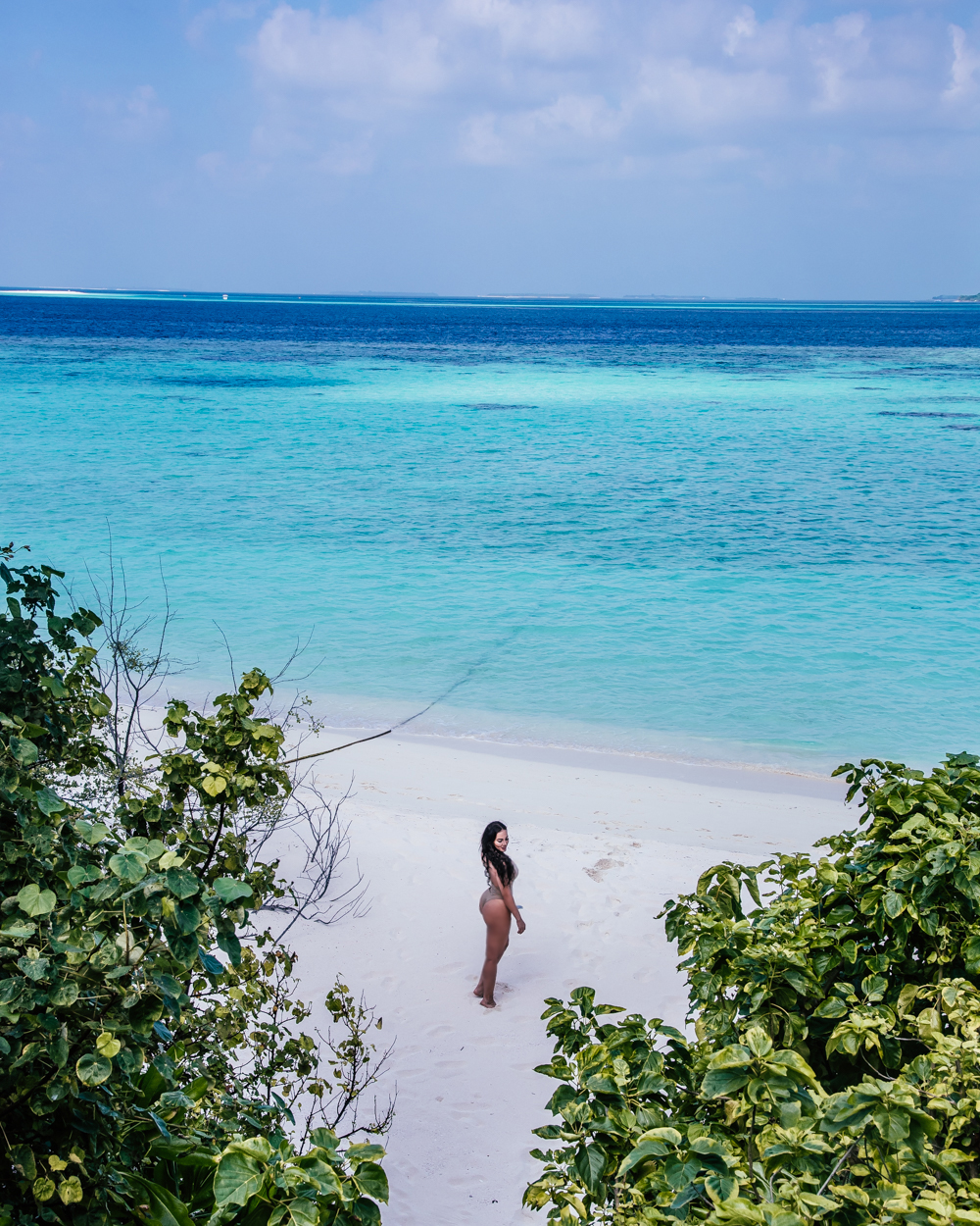 Isabella on a white sand beach in The Maldives