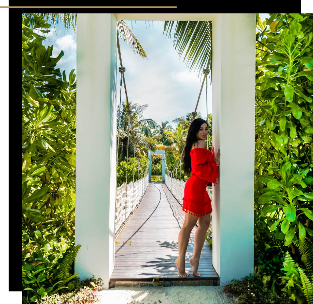 Isabella in a red outfit on the bridge at the Pullman Maldives Maamutaa