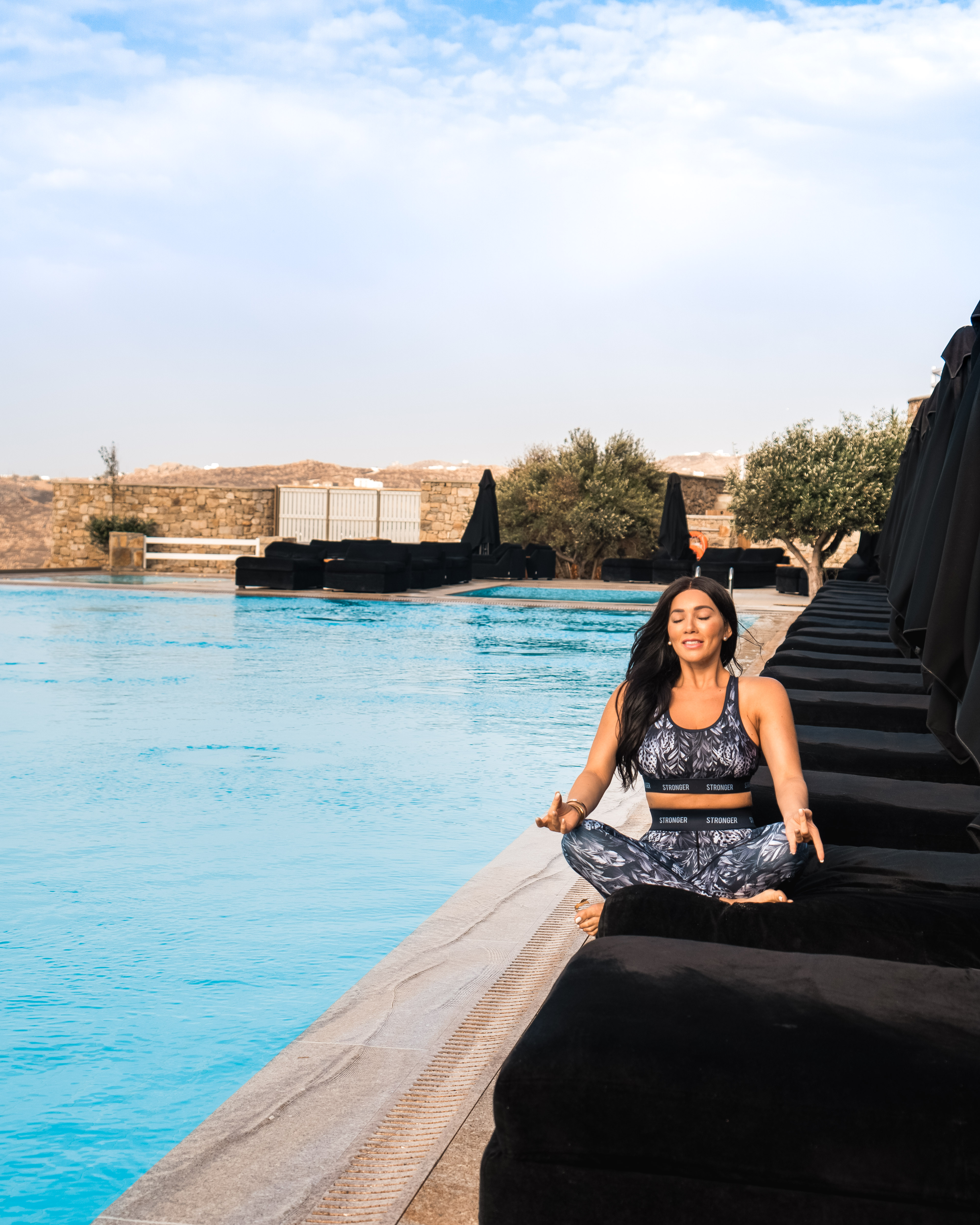 Isabella meditating by the pool