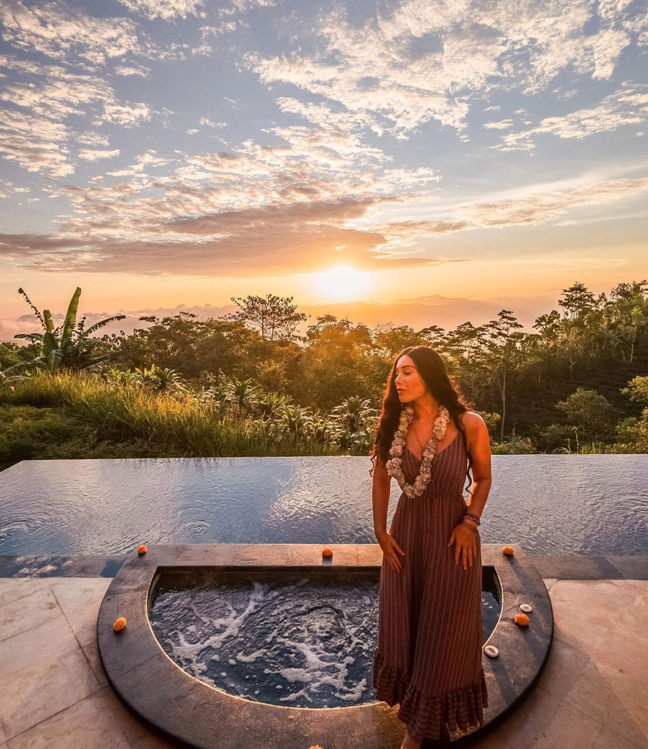 Isabella by a pool at sunset