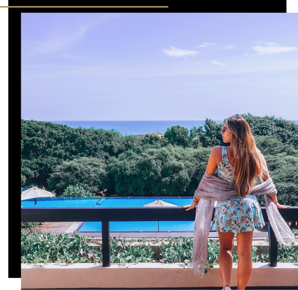 Isabella looking out a pool over a balcony