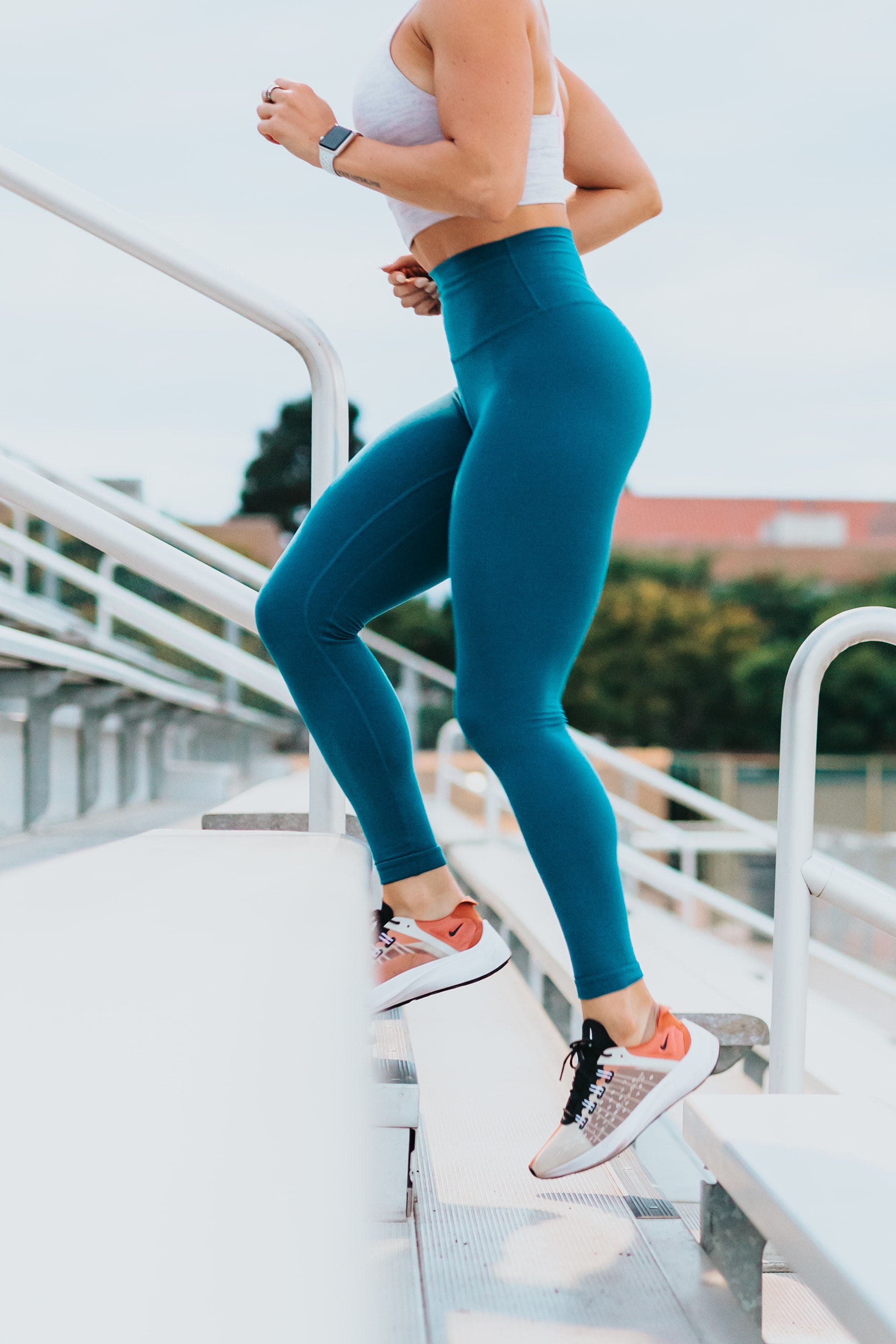 A woman running upstairs in activewear