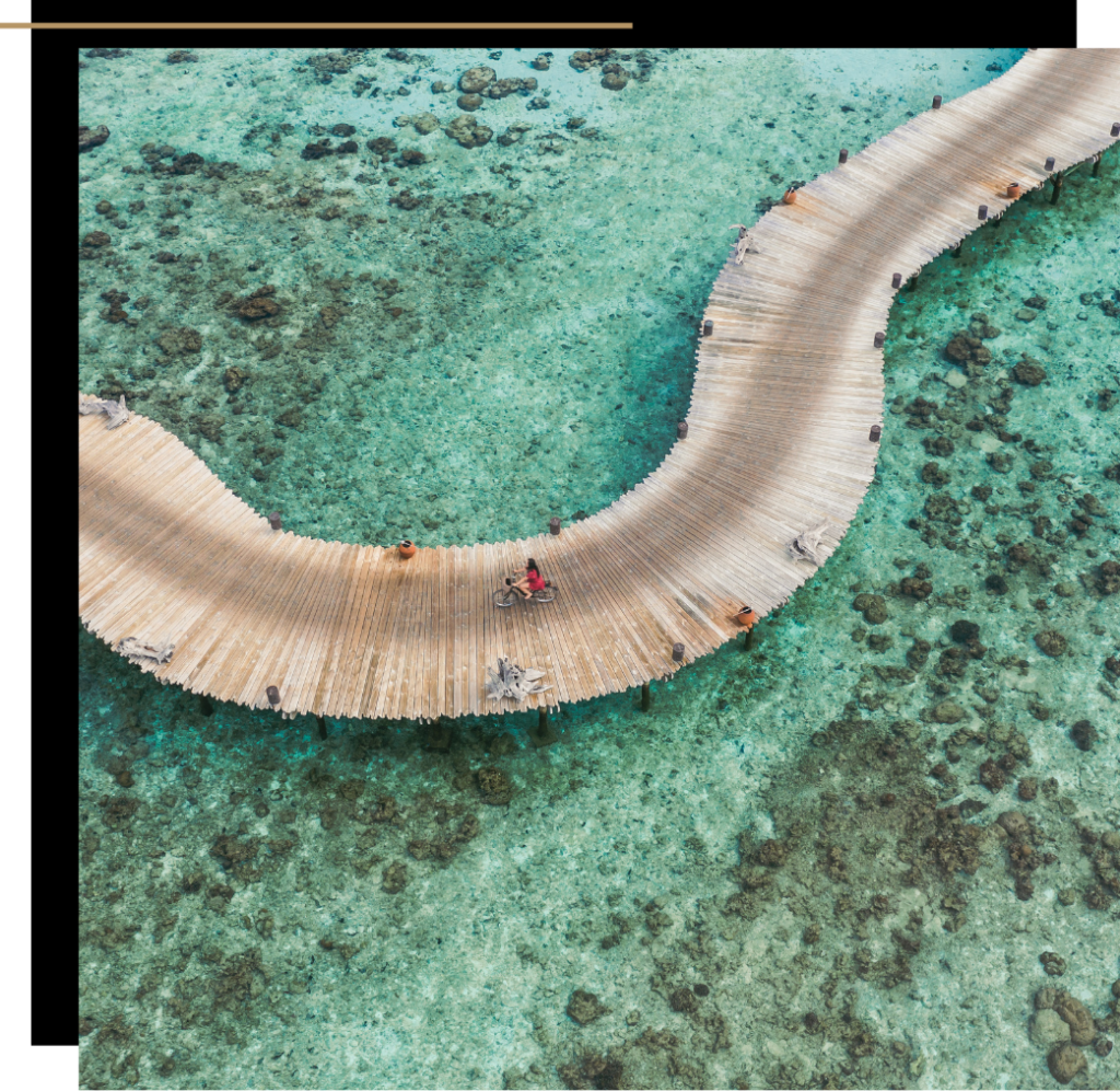 Isabella cycling along the jetty at Soneva Fushi