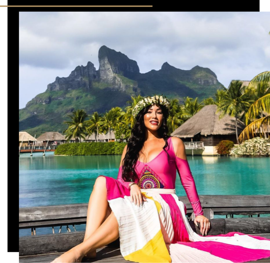 Isabella wearing a flower crown in front of the lagoon at the Four Seasons Resort Bora Bora